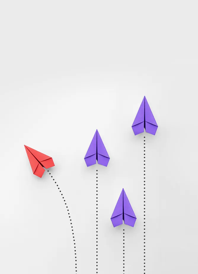 Three purple paper airplanes heading in one direction, one red paper airplane going on a different course