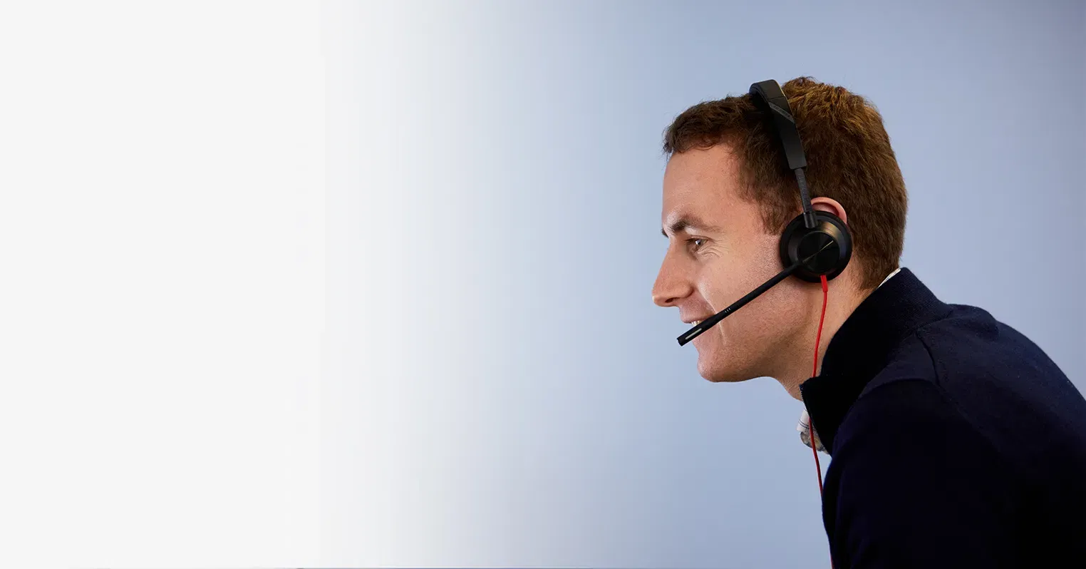 A man in profile wearing a hands-free headset