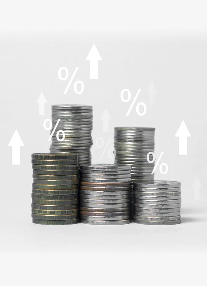 A photo of different stacks of coins, overlaid with arrows pointing upwards and percentage symbols