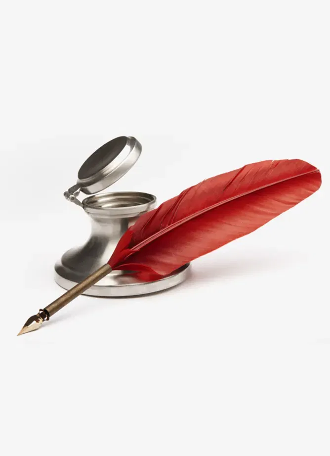 An ink pot with red-feathered quill pen