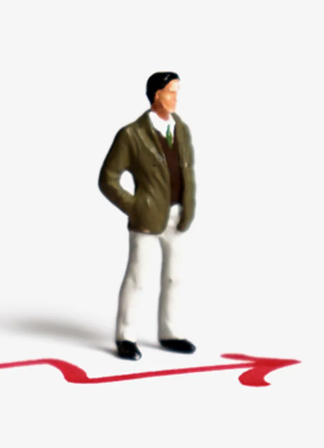 Toy figure of a man stood next to a red arrow drawn on a white surface