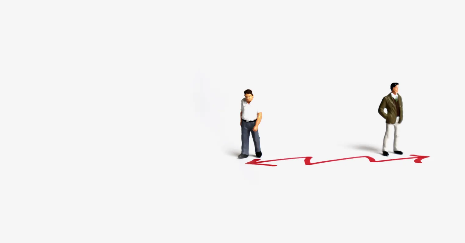 A red, zig-zag arrow on the floor with a toy figure of a man standing at either end