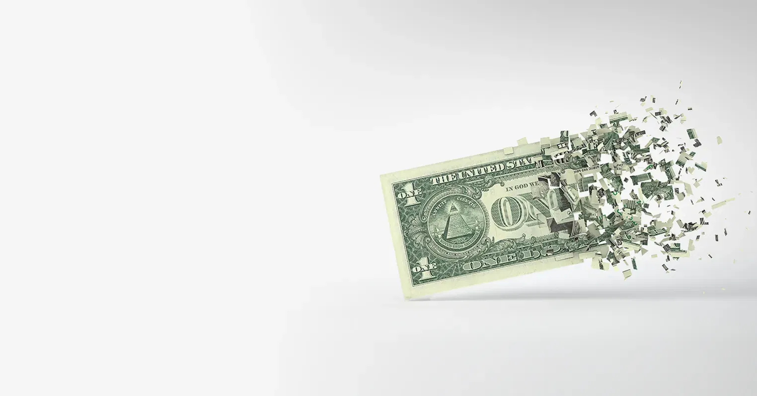 An image of a US one dollar that starts to fracture and fall apart around the middle and the right side is completely in bits