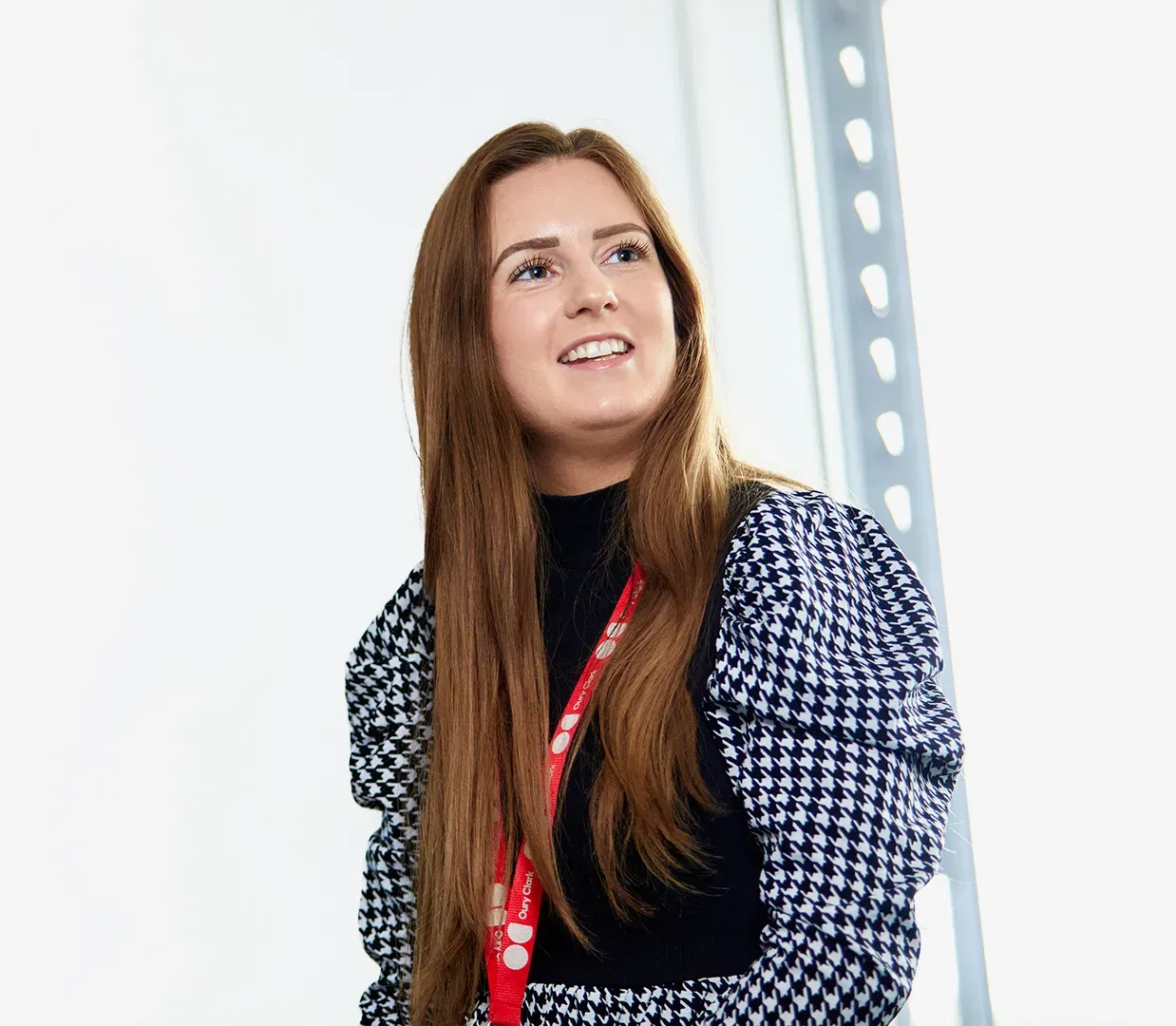 Photo of a smiling woman wearing an Oury Clark lanyard